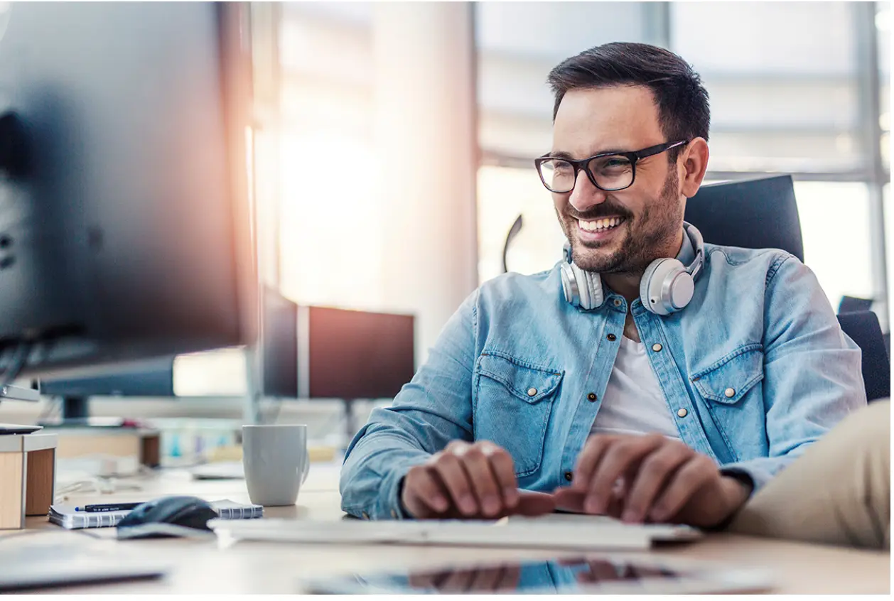 Man smiling at computer
