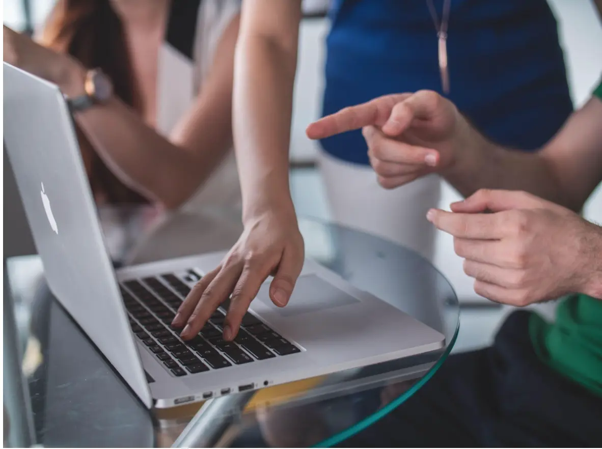 People looking at computer and pointing