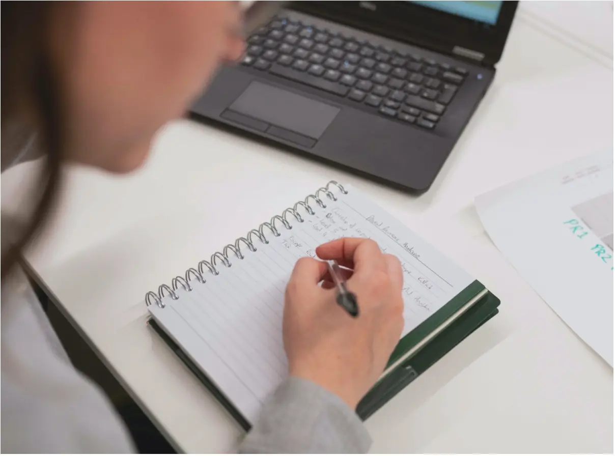 Woman writing in notebook