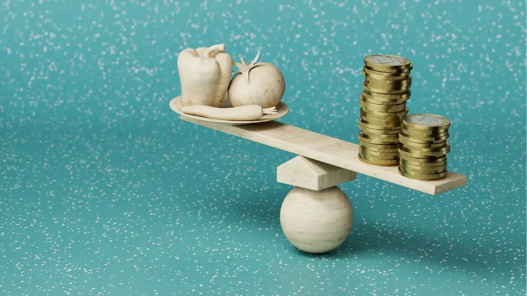 a-scale-with-coins-and-garlic-on-top-of-it