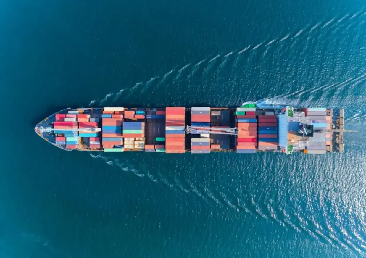 aerial-top-view-container-ship-with-crane-bridge-for-load-container-logistics-import-export-shipping-or-transportation-concept-background