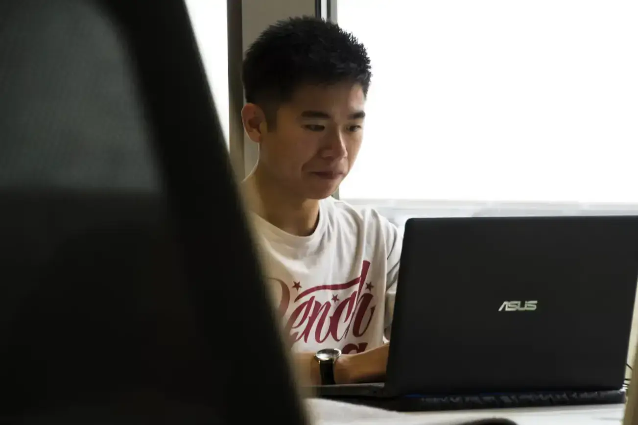 asian-man-working-at-a-laptop