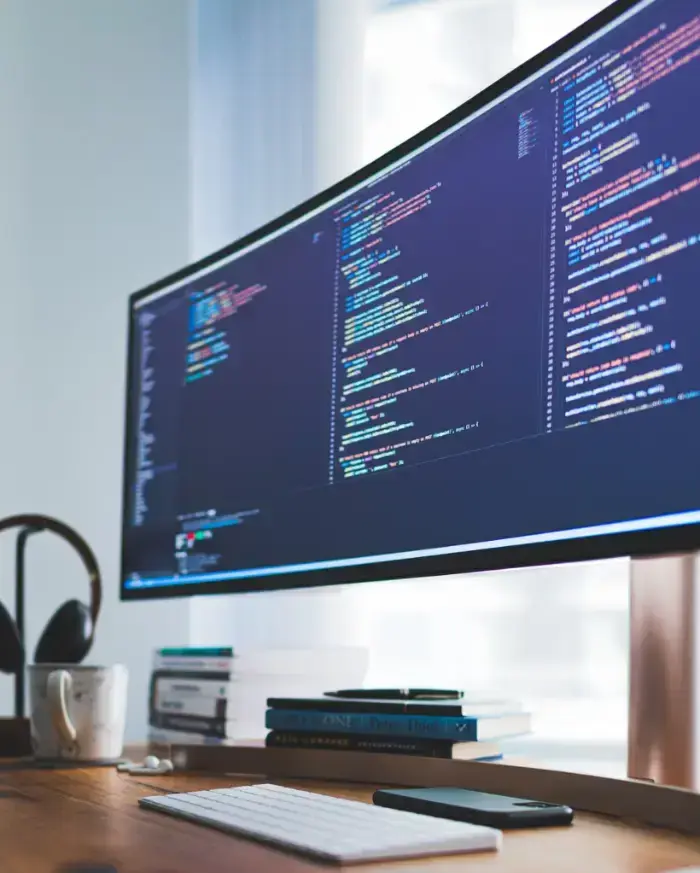 computer-monitor-sitting-on-top-of-a-wooden-desk