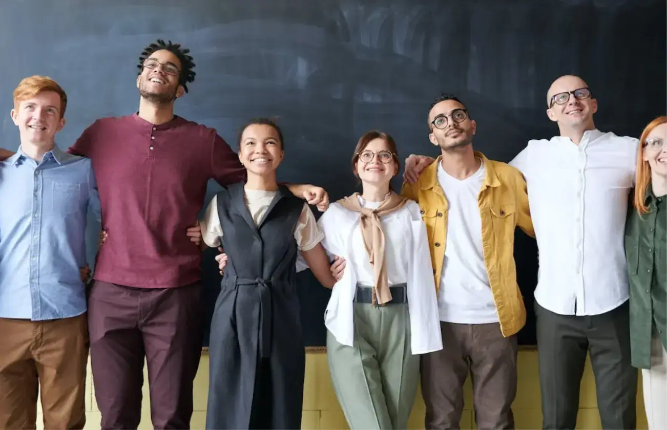 group-of-people-standing-in-a-line-in-front-of-a-blackboard