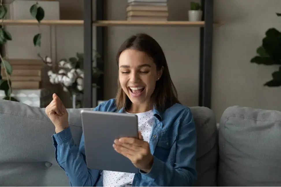 happy-woman-looking-at-tablet
