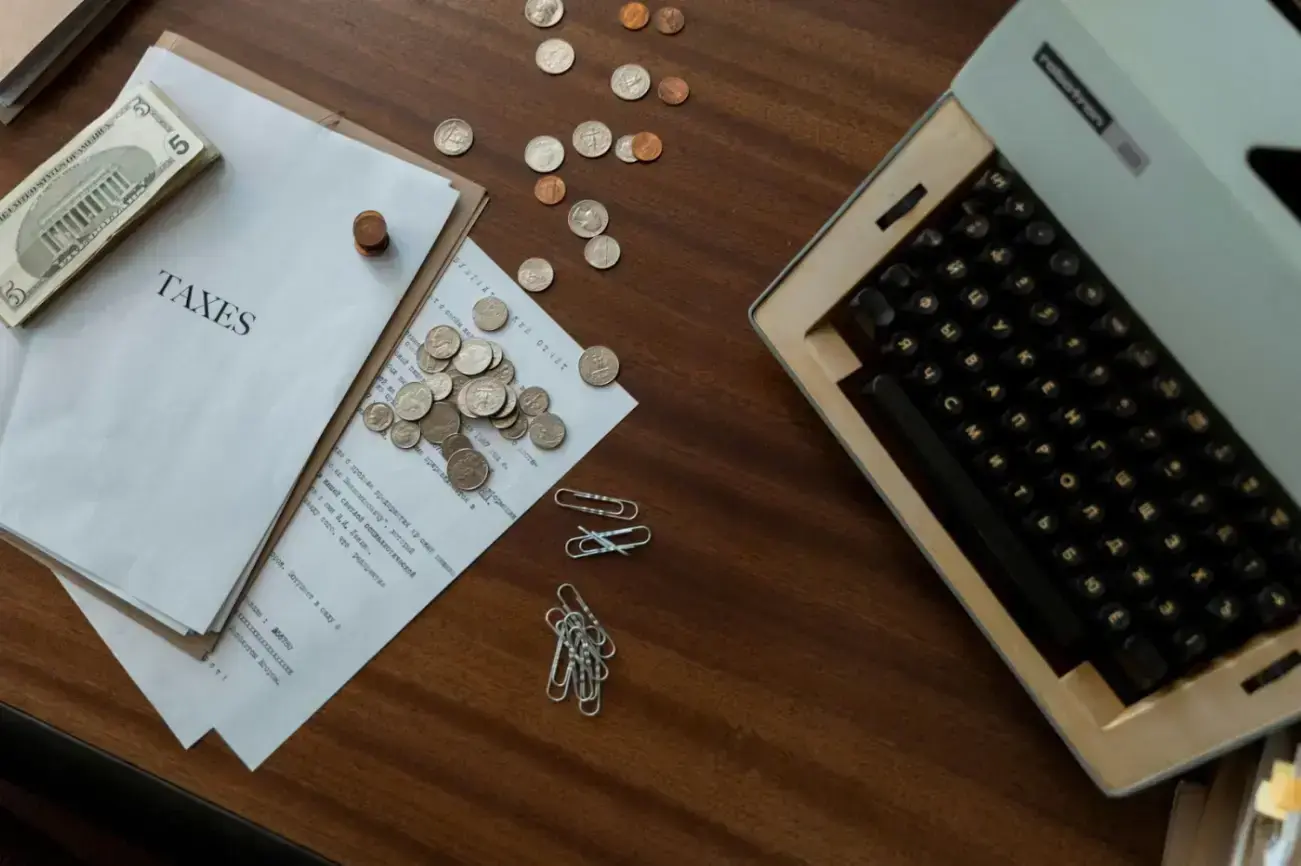high-angle-shot-of-a-typewriter-and-money-on-the-table