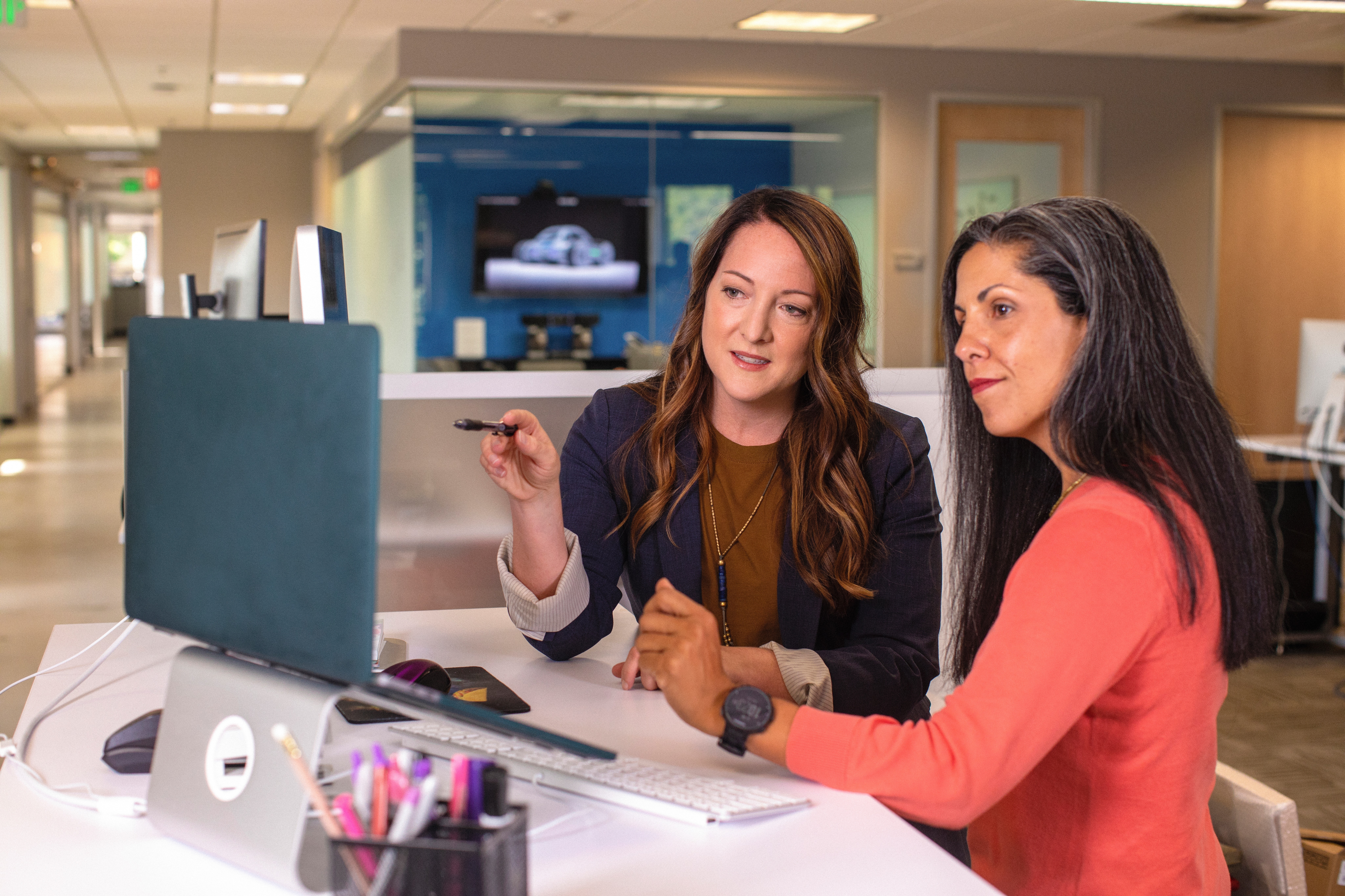 two women working on a project on a computer