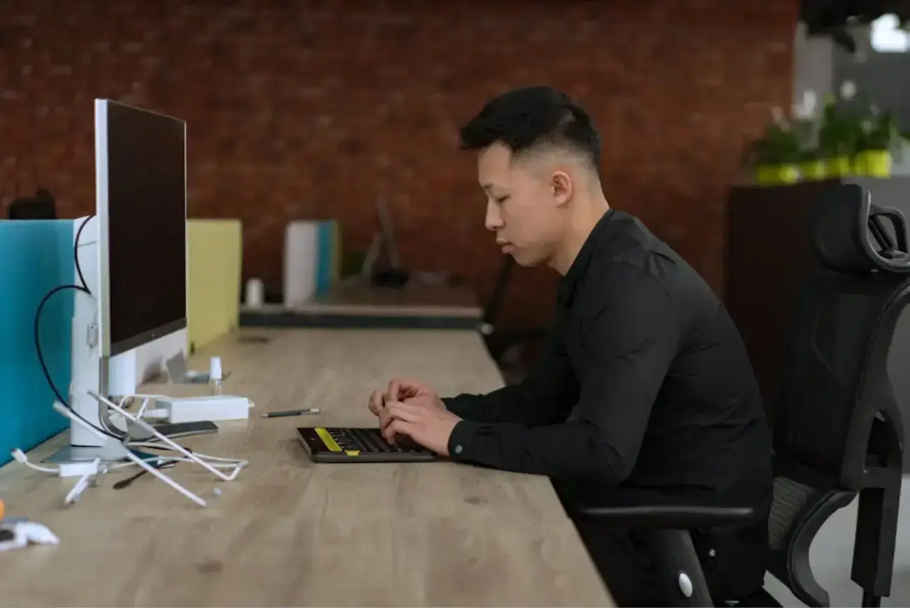 man-in-black-long-sleeve-using-computer
