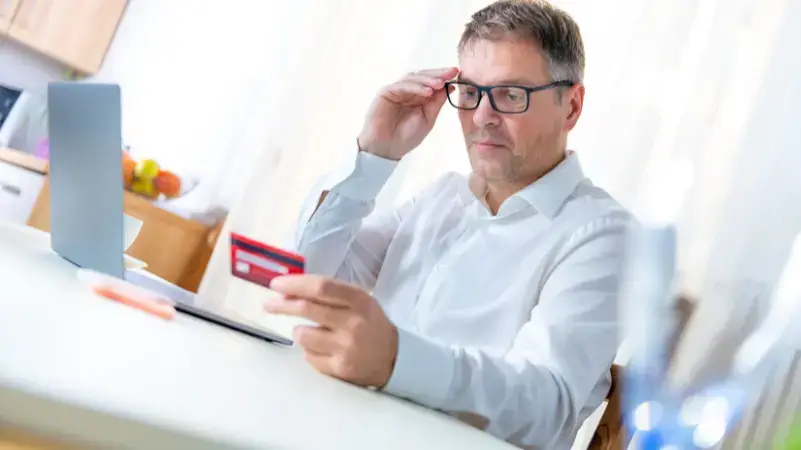 man-looking-at-credit-card
