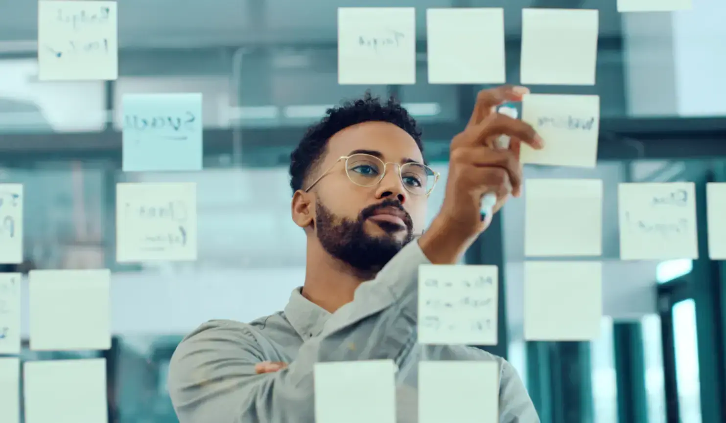 man-reviewing-a-sticky-note