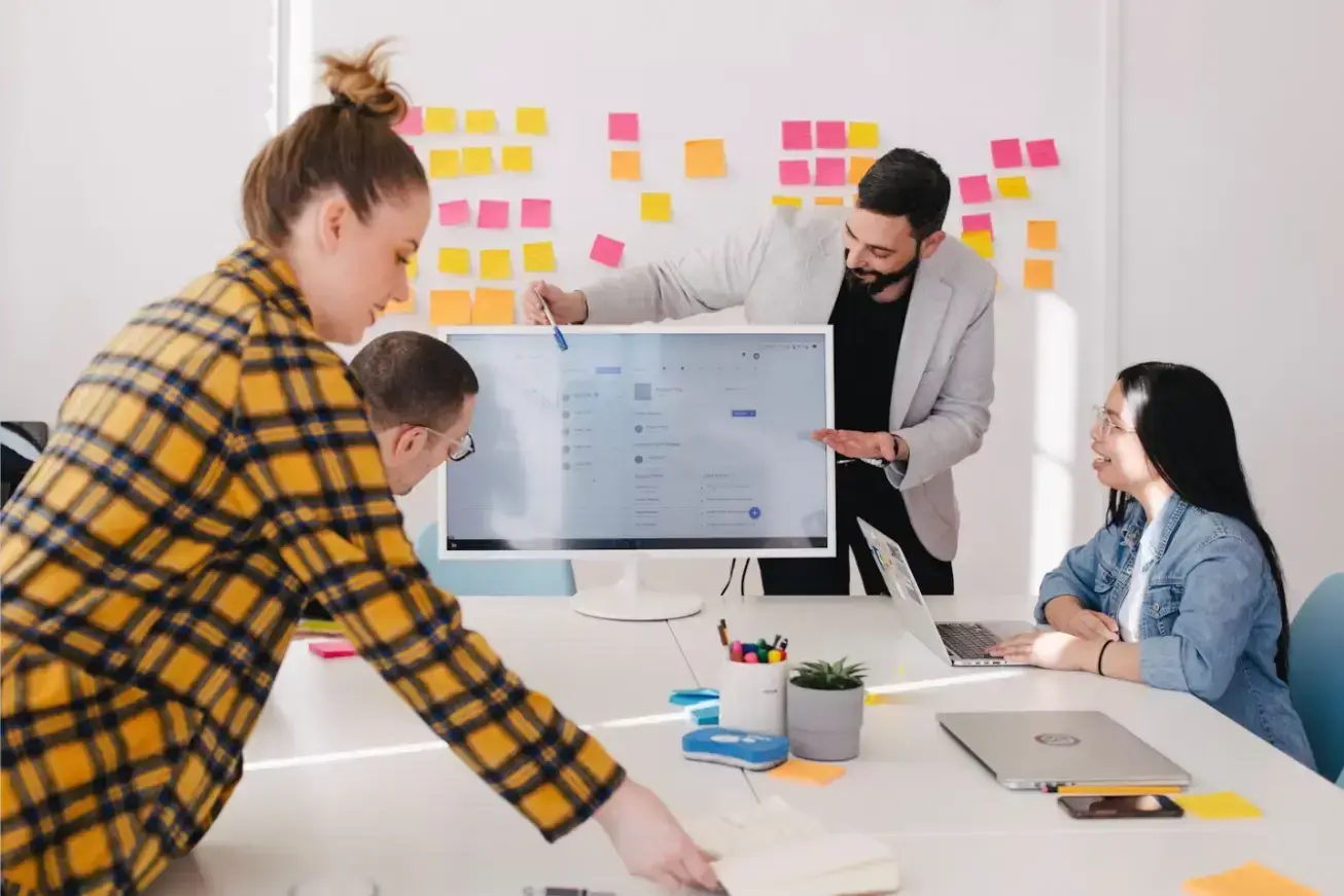 man-standing-behind-flat-screen-computer-monitor