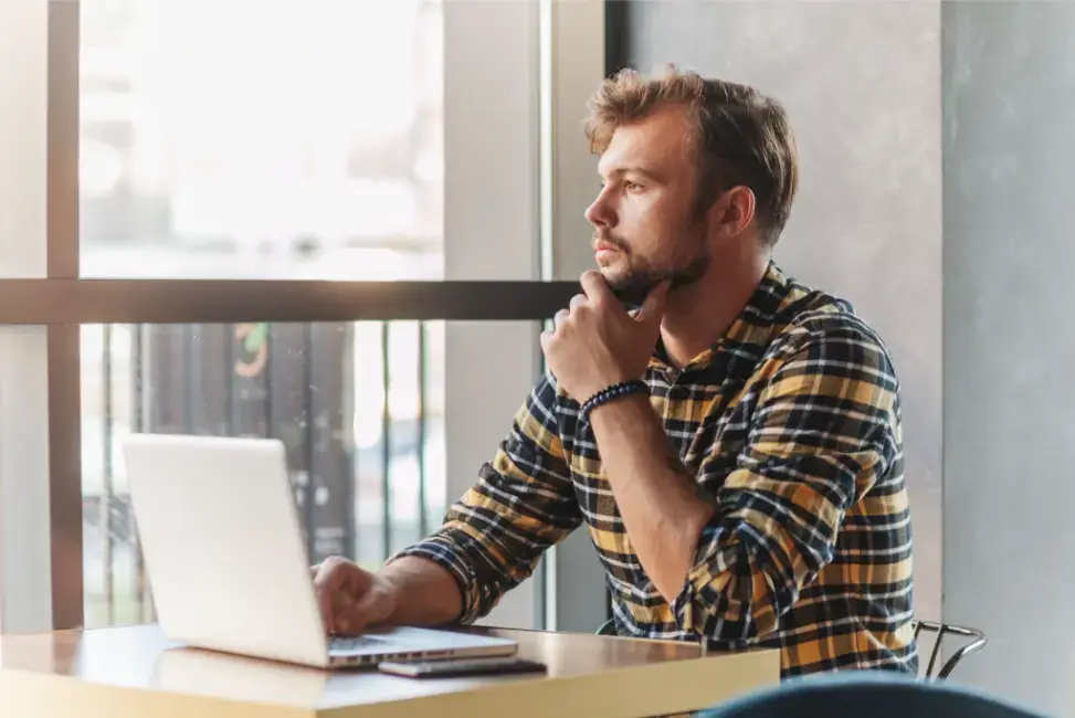 man-thinking-in-front-of-laptop