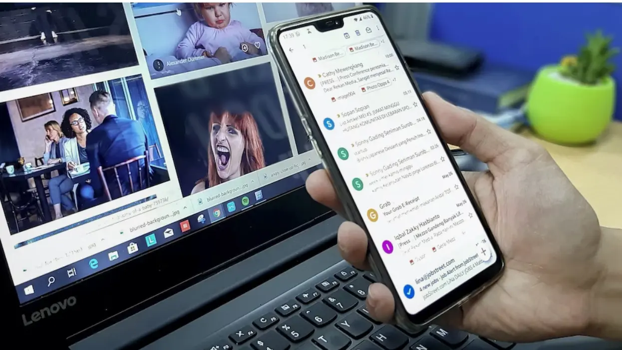 person browsing gmail on phone