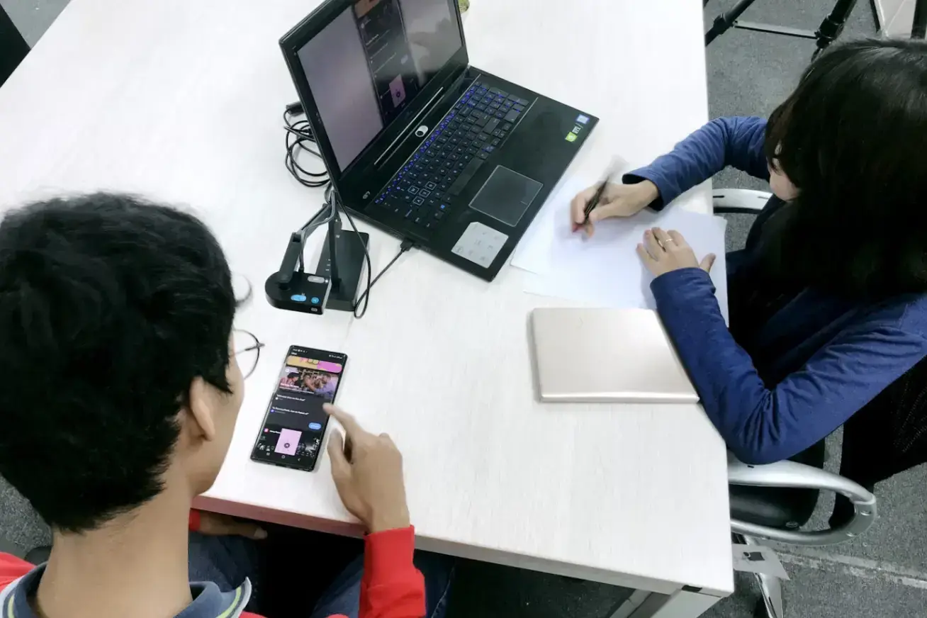 person-in-blue-long-sleeve-shirt-using-black-laptop-computer