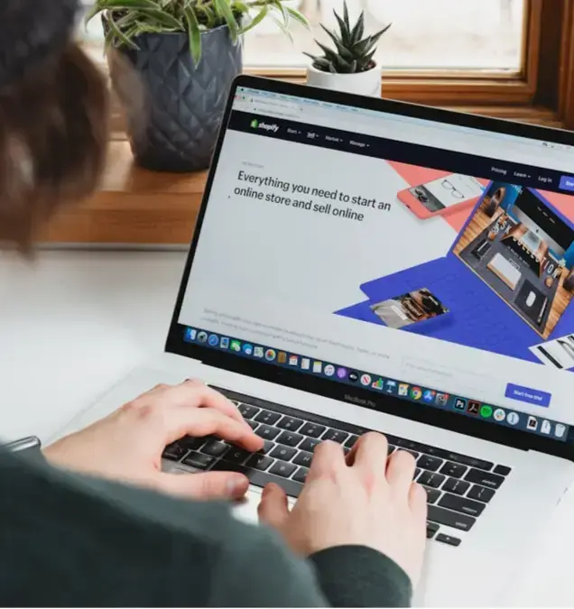 person-using-macbook-pro-on-white-table