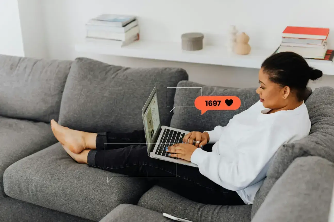 woman-in-white-long-sleeves-sitting-on-a-sofa-while-using-a-laptop