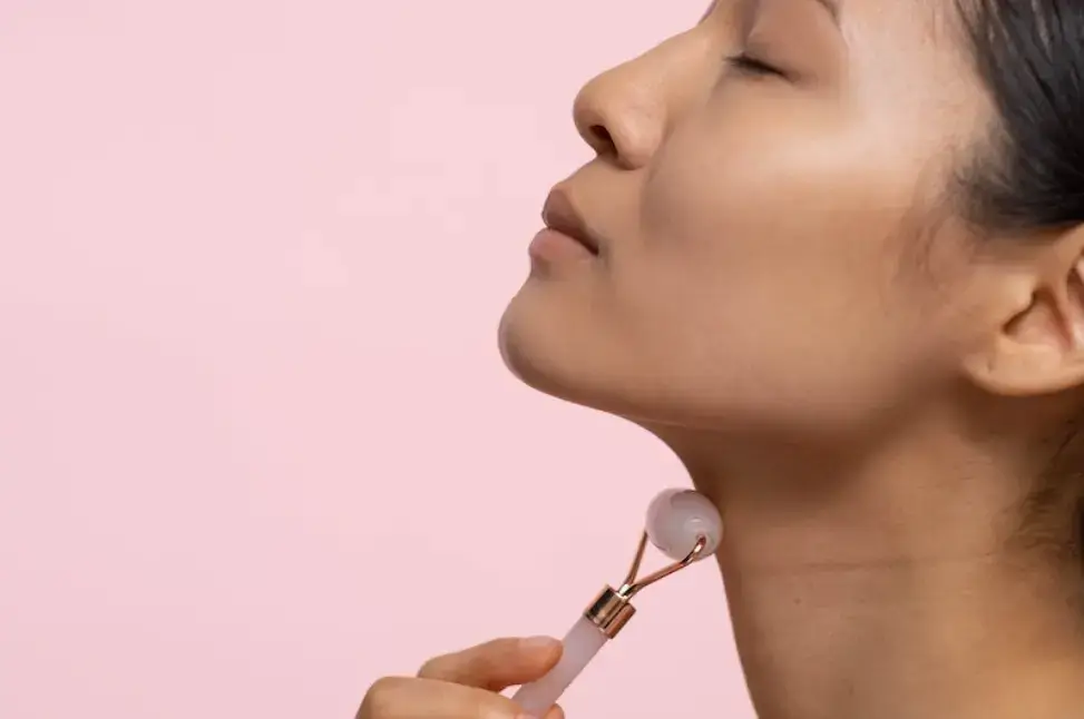 woman-using-facial-roller-on-neck